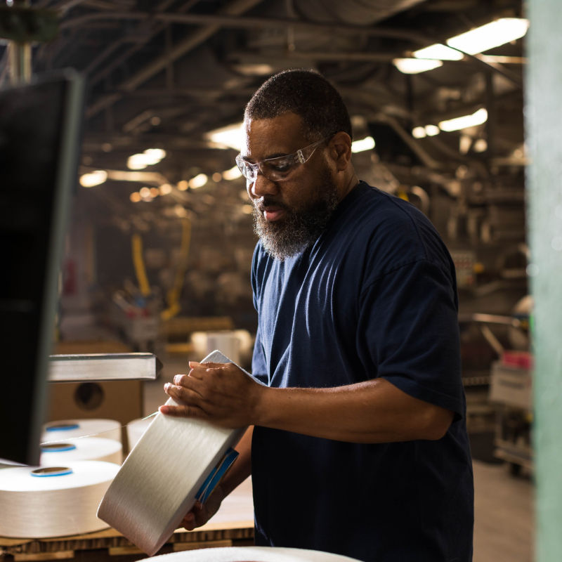 a man holding a roll of paper