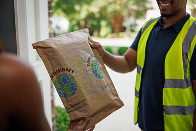 a man handing a bag of food to a woman
