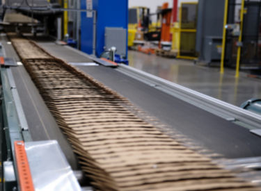 a conveyor belt with cardboard boxes