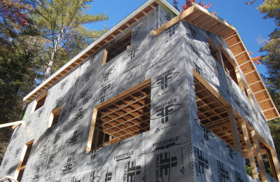a house under construction with wood beams