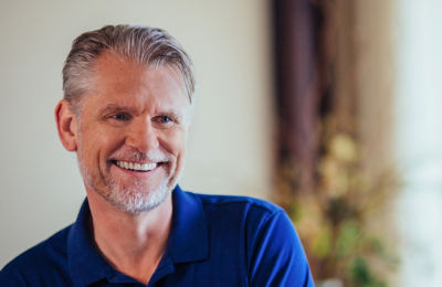 a man smiling at the camera