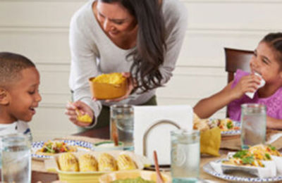 a woman and child eating at a table