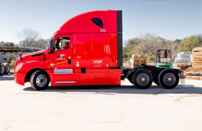 a red semi truck with a forklift