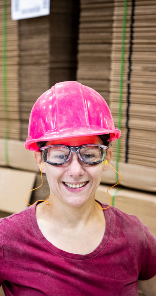 a woman wearing a hard hat and glasses