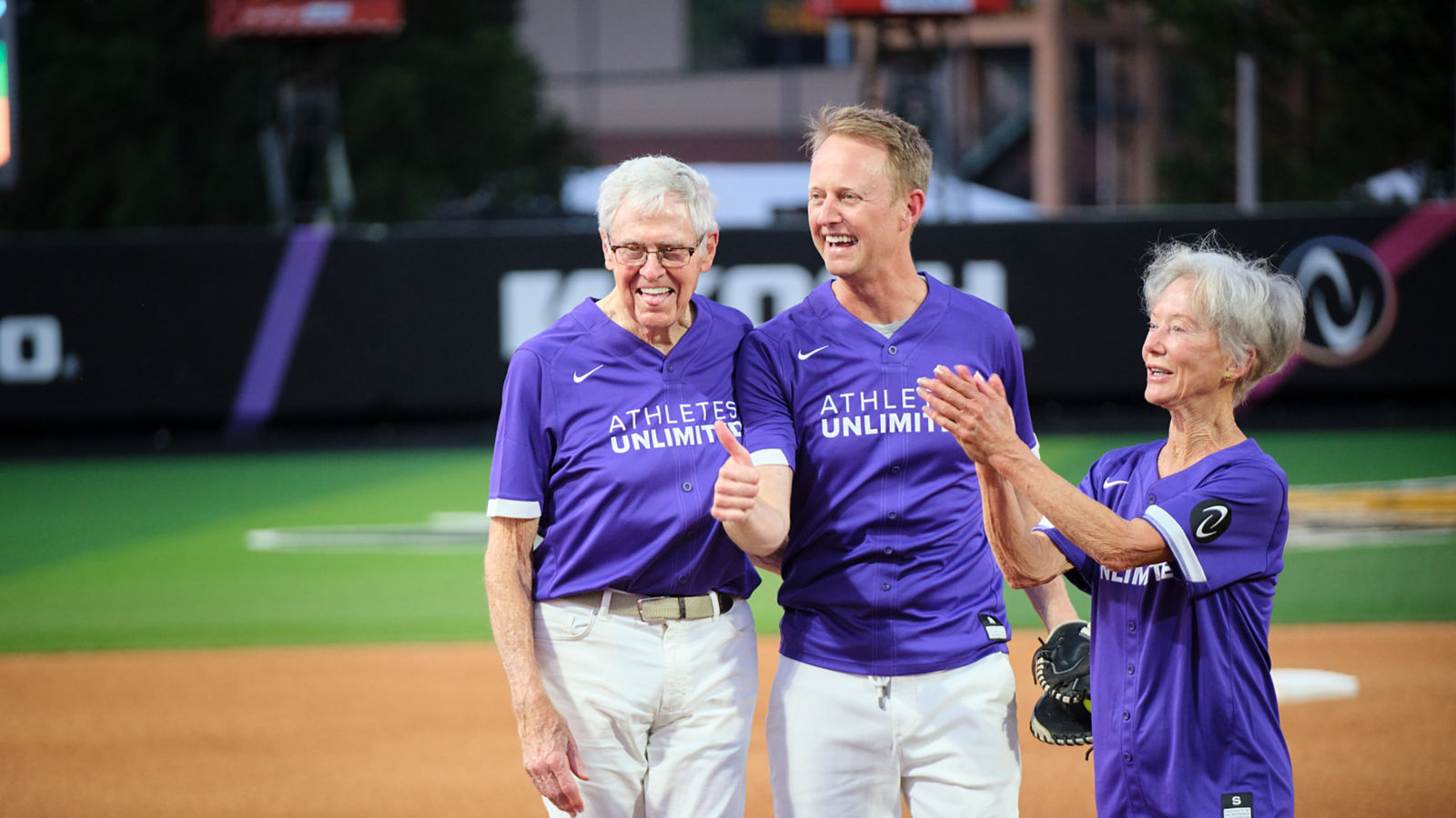 a group of people in purple shirts