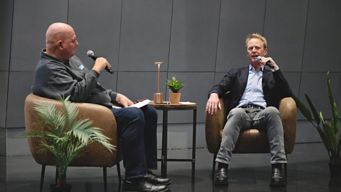 a man talking to another man