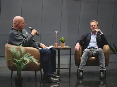 a man talking to another man