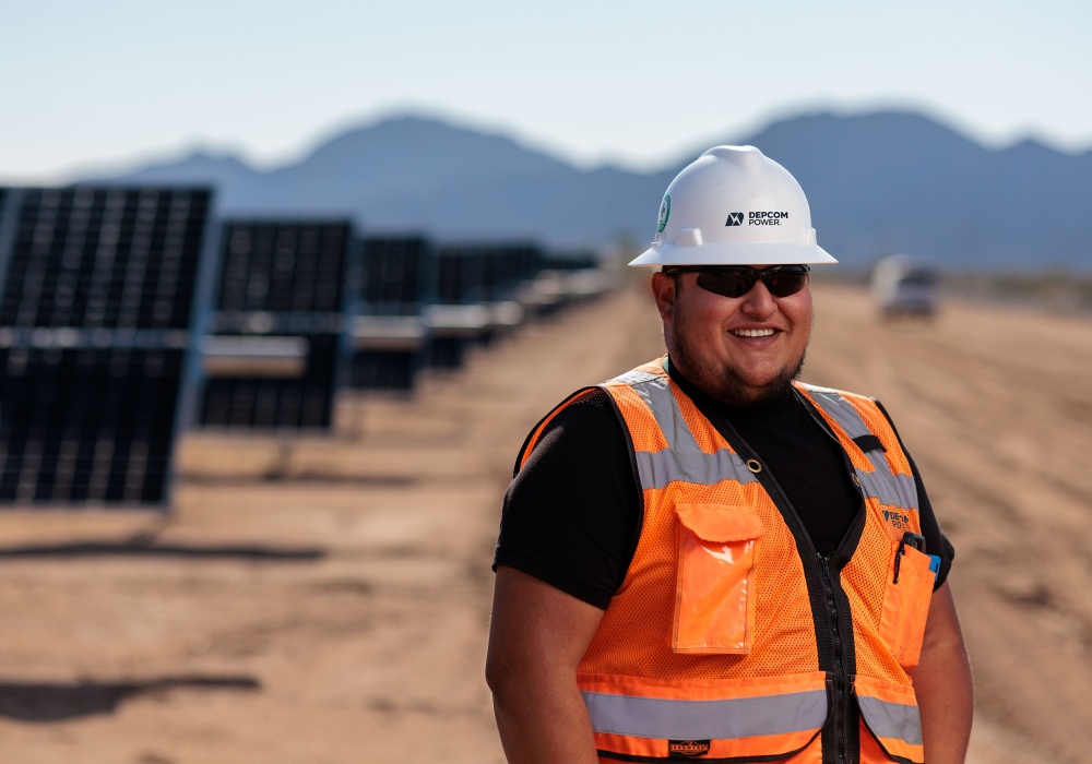 a man in a hard hat and orange vest