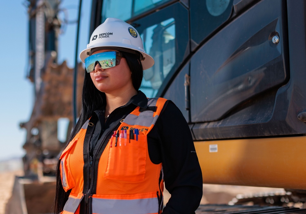 a woman in a hard hat and safety vest