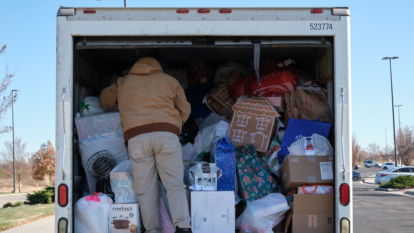 a man standing in the back of a truck full of boxes