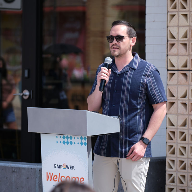 a man standing at a podium holding a microphone