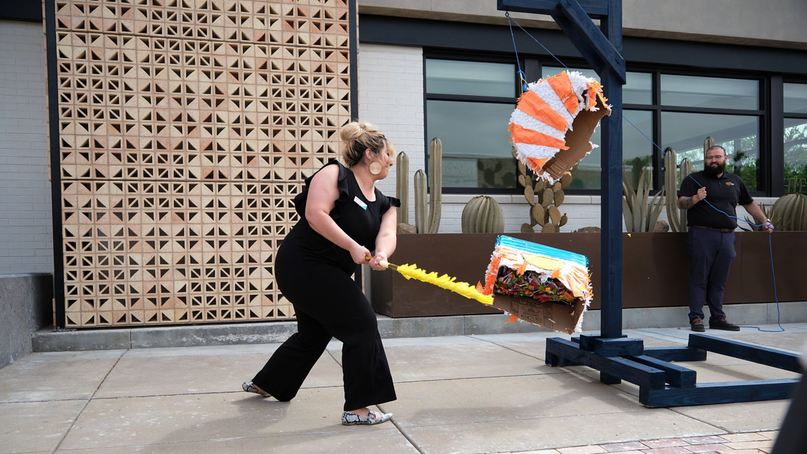 a woman pulling a large box with a yellow object