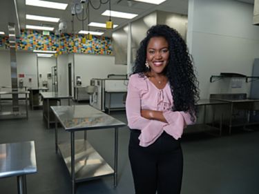 a woman standing in a kitchen