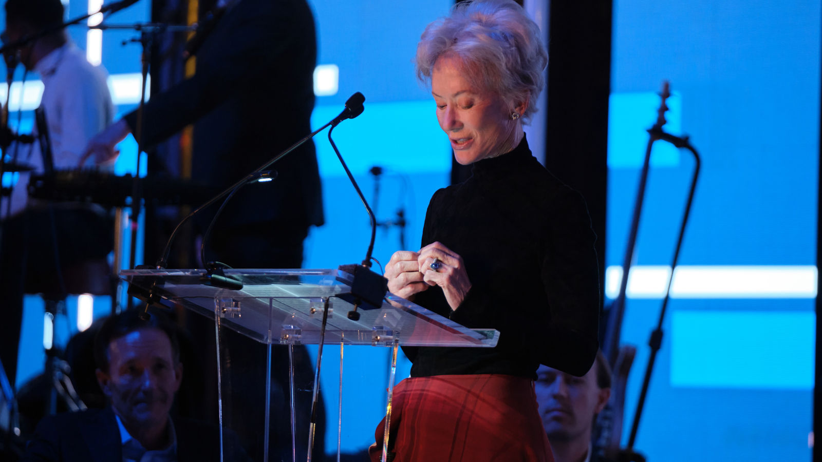 a woman standing at a podium