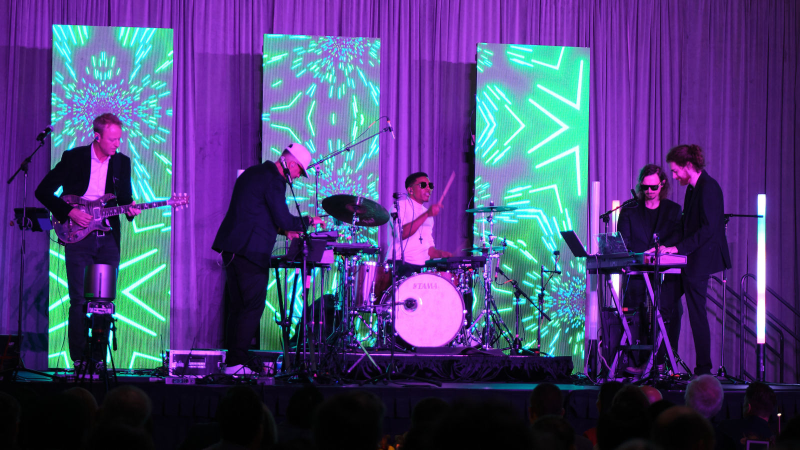 a group of people playing instruments on a stage