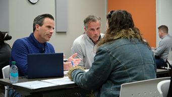 a group of people sitting at a table
