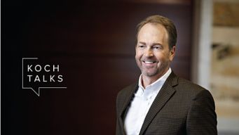 a man in a suit smiling