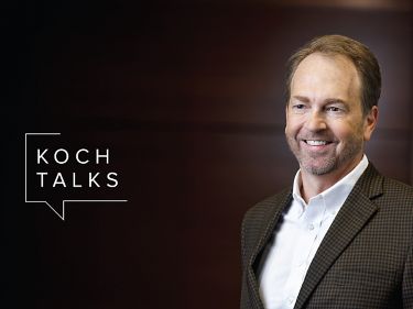 a man in a suit smiling