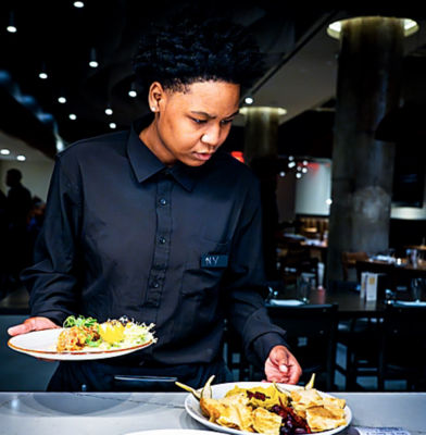 a woman holding plates of food