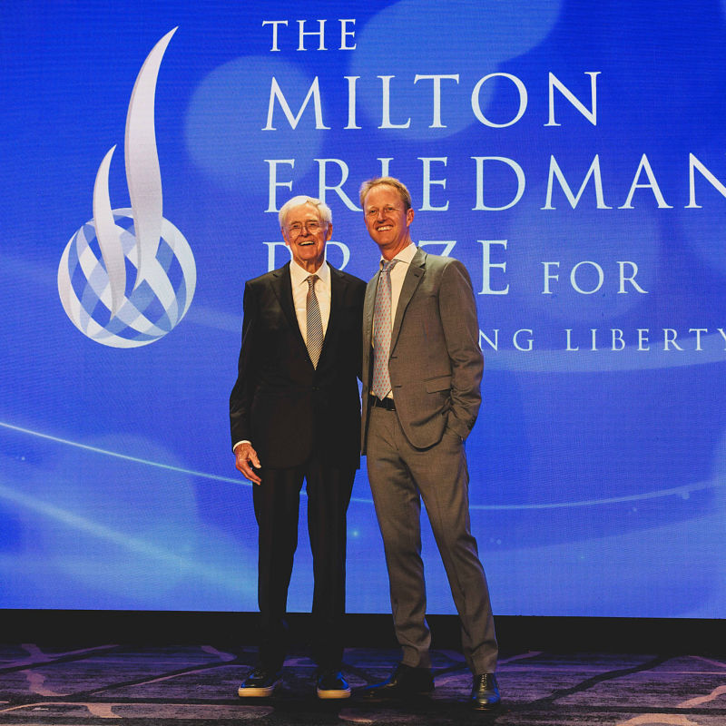 two men standing on a stage