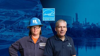 a man and woman wearing hardhats