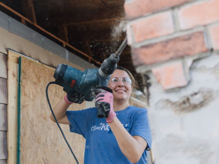 a woman using a drill