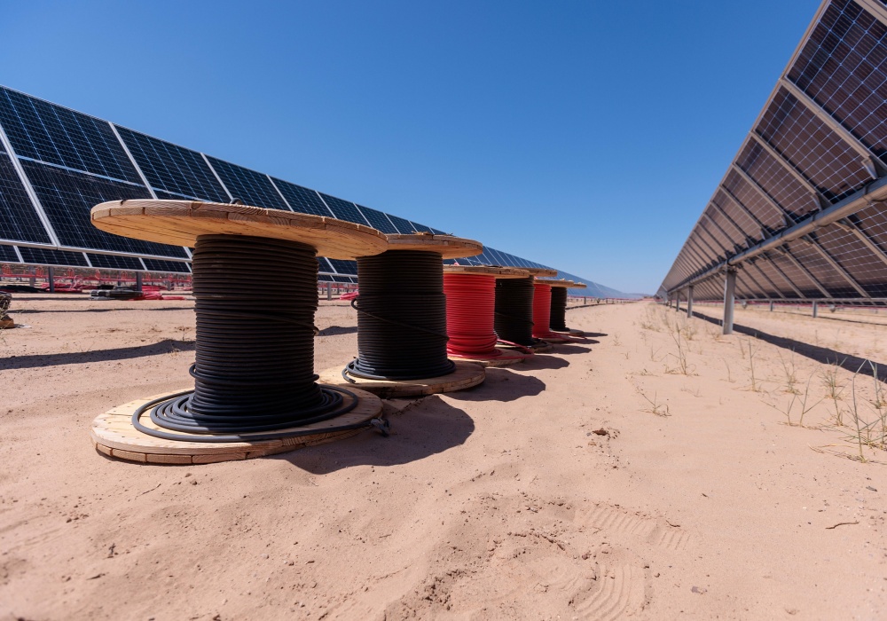 a row of wire spools in a desert