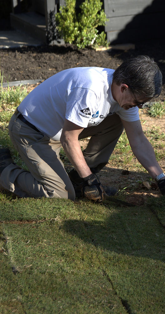 a man kneeling in the grass