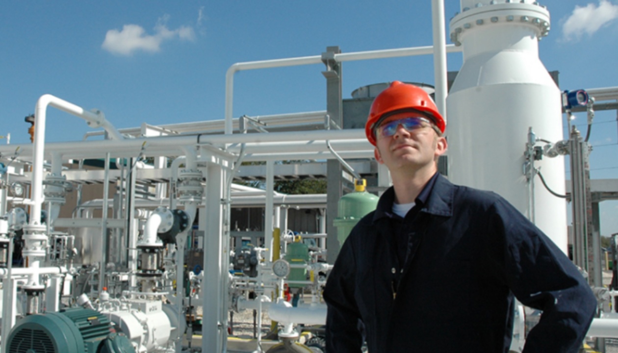 a man wearing a hard hat and glasses