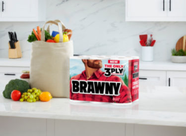 a bag of groceries next to a box of toilet paper