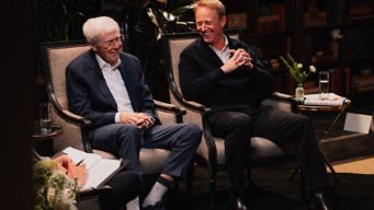 a couple of men sitting in chairs