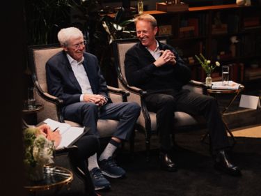 a couple of men sitting in chairs