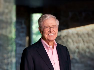 a man in a suit smiling