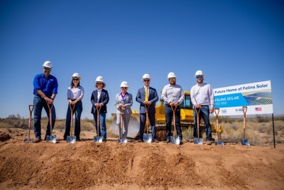 a group of people wearing hard hats and holding shovels