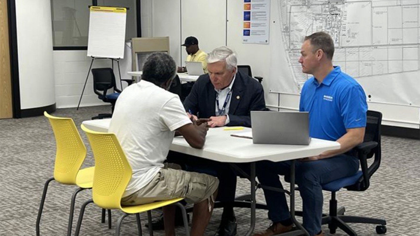 a group of men sitting at a table
