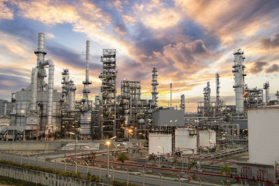 a large industrial plant with a cloudy sky