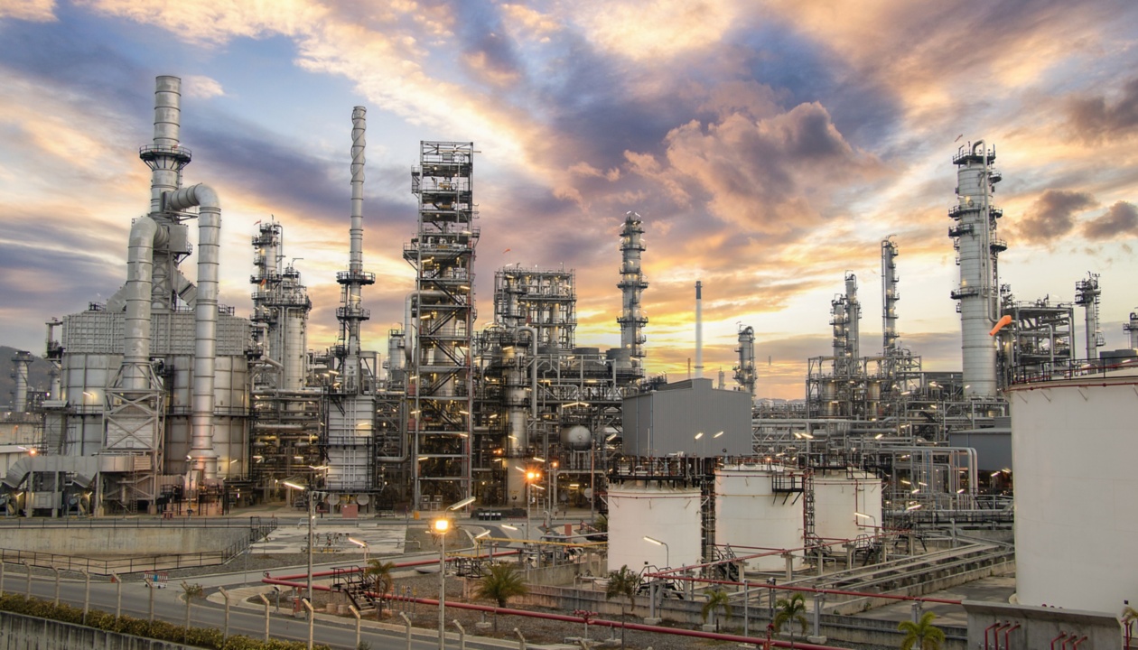 a large industrial plant with a cloudy sky