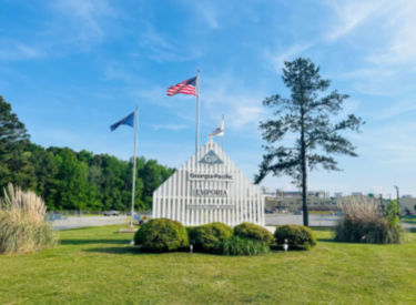 a white fence with flags on top of it