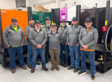 a group of men standing in a room