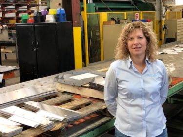 a woman standing in a factory