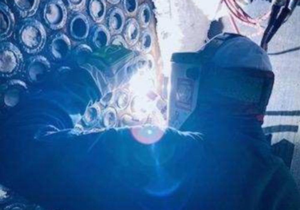a person welding a wall