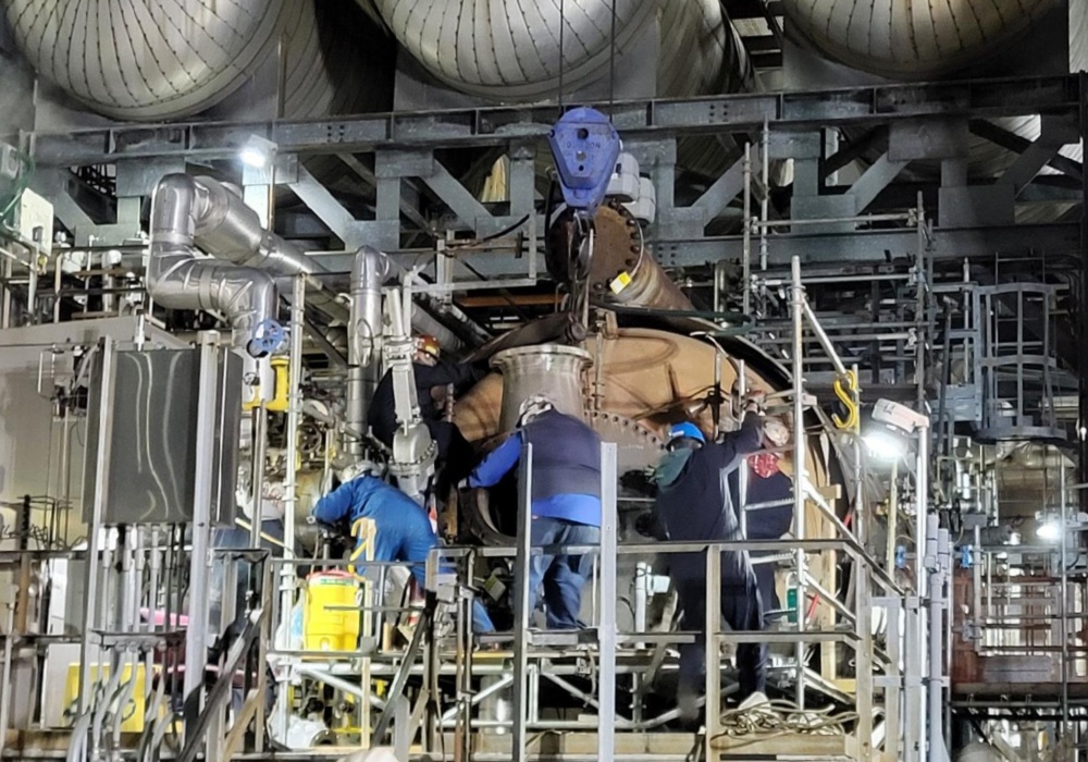 a group of men working on a machine
