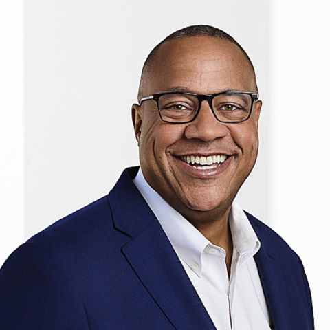 a man wearing glasses and a blue jacket