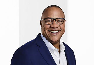 a man wearing glasses and a blue jacket