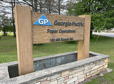 a sign in a stone wall