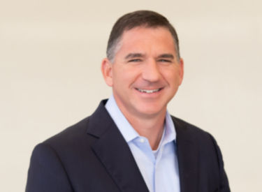 a man in a suit smiling