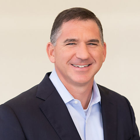 a man in a suit smiling