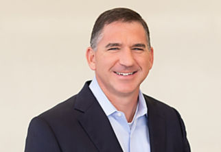 a man in a suit smiling