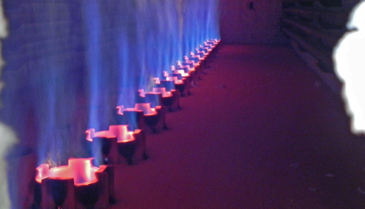 a row of candles with blue and red flames