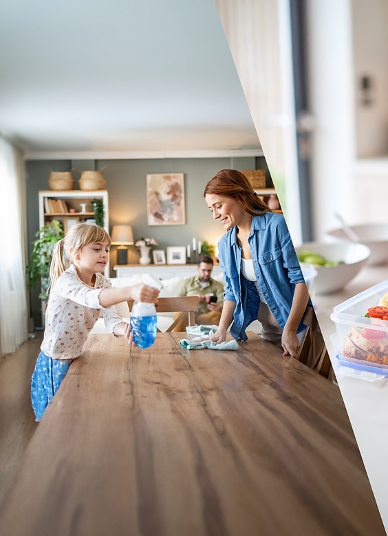 a woman and a child cleaning a table